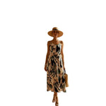 Woman wearing a floral dress in a casual setting with a chair and decorative items.