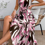 Woman wearing a patterned dress sitting on a chair indoors.