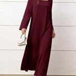 Woman wearing a burgundy dress with a white background