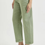Person wearing green jeans on a white background