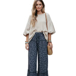 Leopard print pants worn by a person on a white background