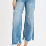 Person wearing light blue jeans with a white background