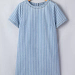 Blue and white striped dress on a wooden hanger against a light gray background