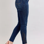Blue jeans with cargo pockets worn by a person on a light gray background