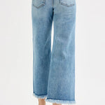 Light blue jeans worn by a person on a white background
