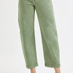 Green jeans worn by a person on a white background