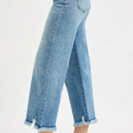 Light blue jeans with frayed cuffs on a white background