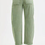Green jeans worn by a person on a white background