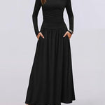 Black long-sleeve dress worn by a model on a light gray background