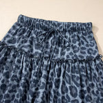 Blue leopard print pants on a beige background