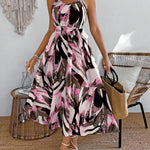 Woman wearing a floral dress in a room with a chair and decorative wall hanging.