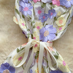 Decorative headband with floral designs on a soft surface