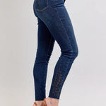 Blue jeans worn by a person on a white background